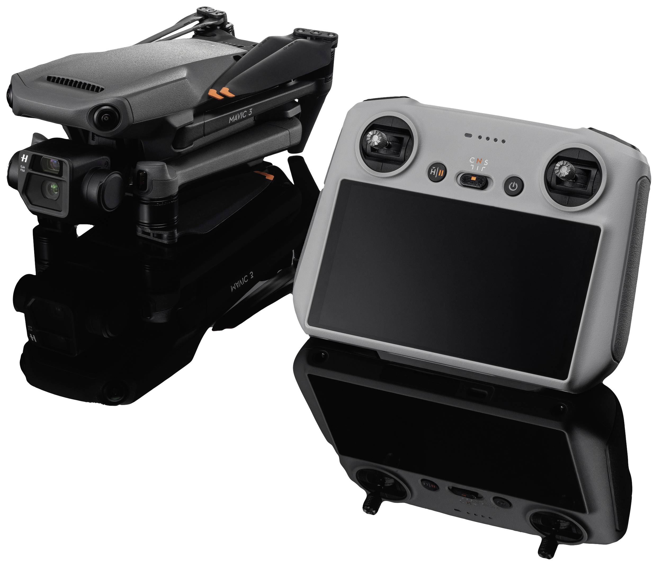 A packed drone next to a remote control with a screen. The drone is compactly folded. Both devices are dark grey.