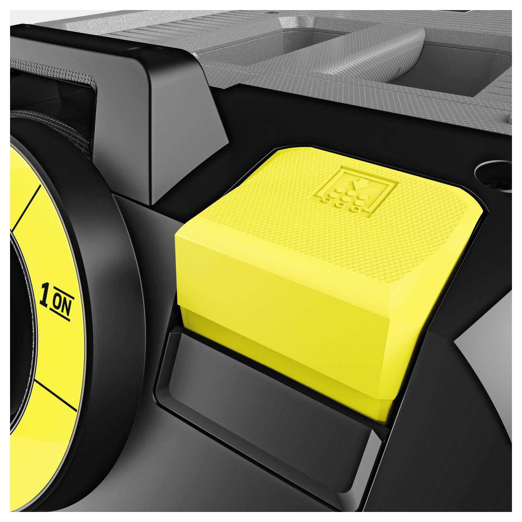 Close-up of a yellow button with a textured surface on a black and gray device, featuring a faint symbol, suggesting functionality.