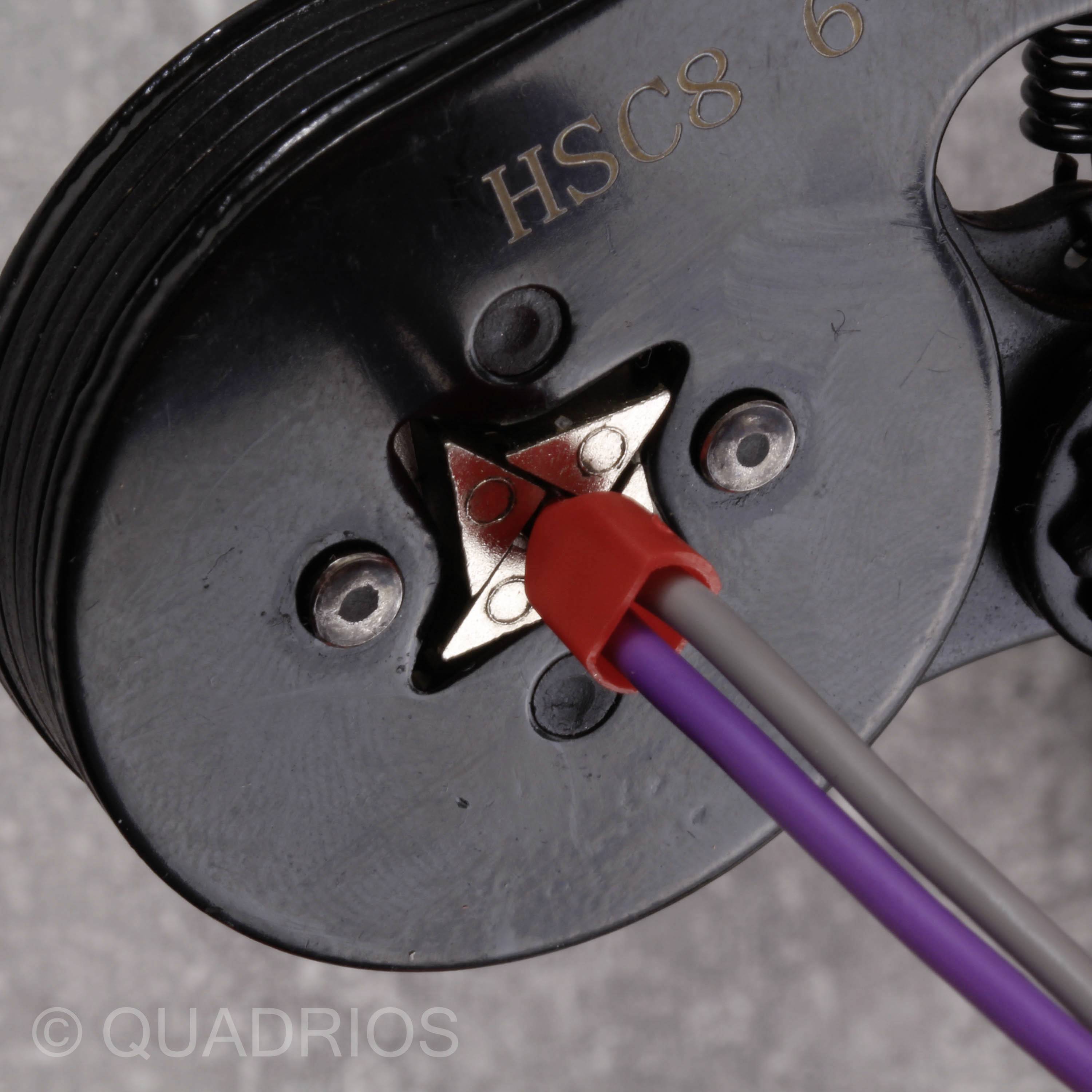 Close-up of a black electrical component with printed label 'HSC8 6'. Two cables, one red and one purple, are connected.