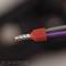 Close-up of an electrical cable with red plastic insulation at the end.
