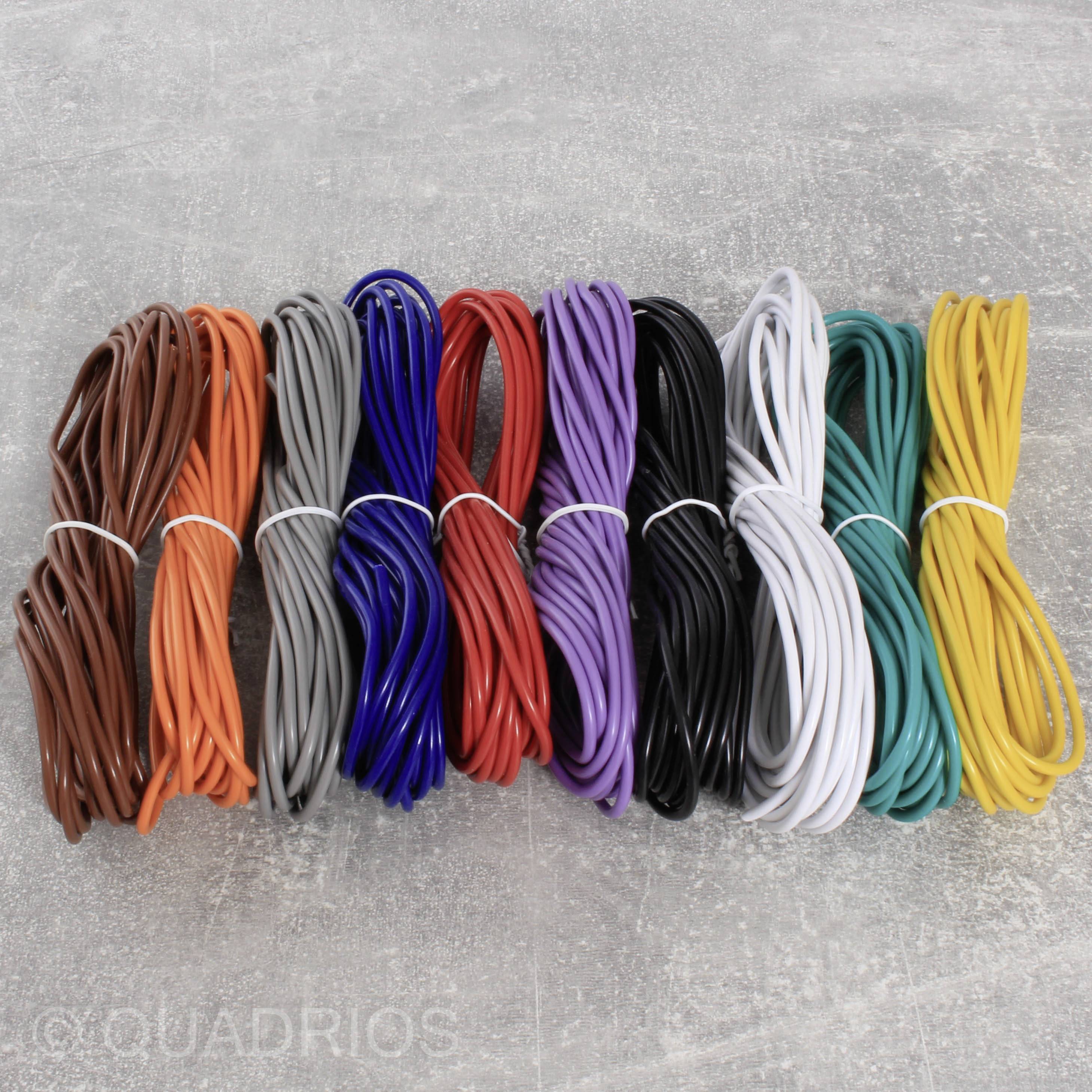 Colour photograph of ten differently coloured cable bundles, lying on a grey background. Bundles in brown, orange, grey, blue, red, purple, black, white, green and yellow.
