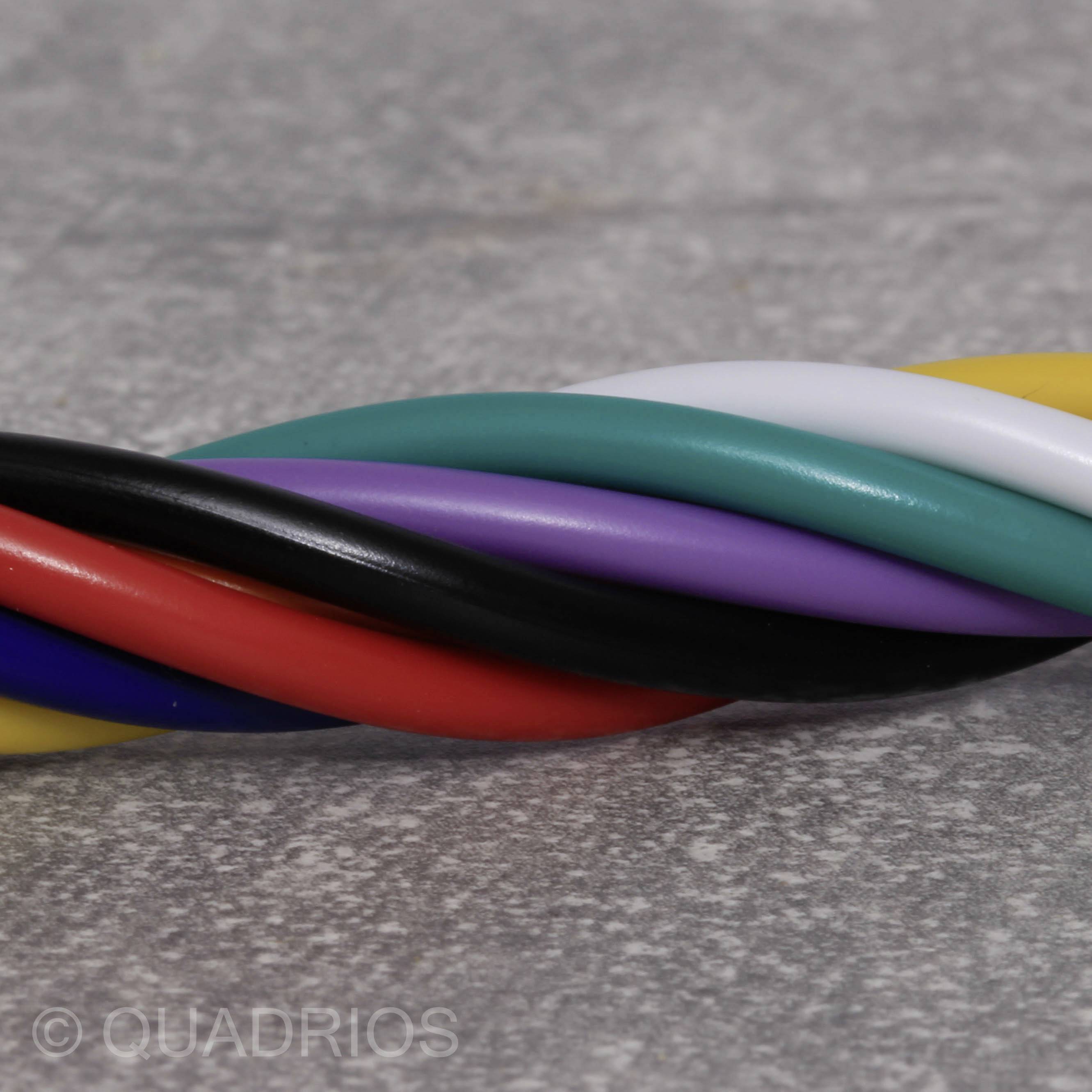 Close-up of several intertwined cables in different colours: red, black, blue, green, purple, yellow, white.