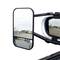 A lorry side mirror showing a mirror-image view of a road and surrounding area.