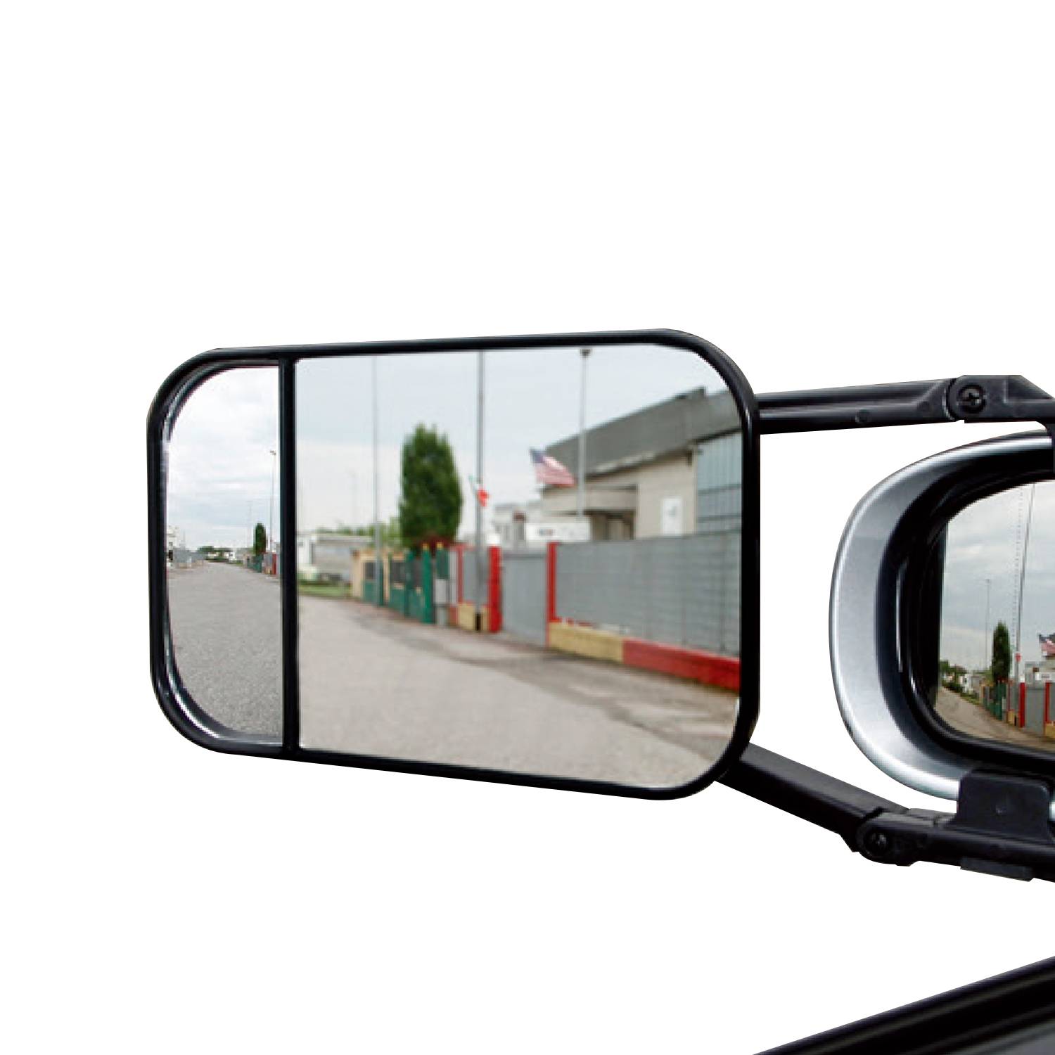 Rear-view mirror of a vehicle shows the roadside and a gate with a flag. Reflection conveys the driver's perspective.