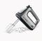 A silver hand mixer with black accents and removable beaters and dough hooks is lying on a surface.