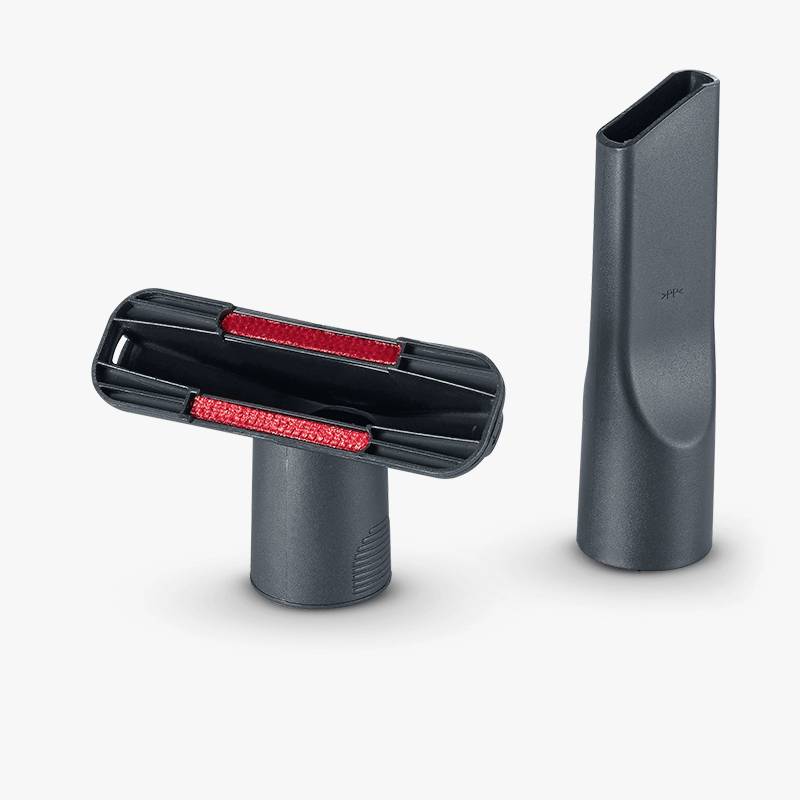 Two vacuum cleaner nozzles: on the left, a wider upholstery nozzle with red brushes, on the right, a narrow crevice tool.