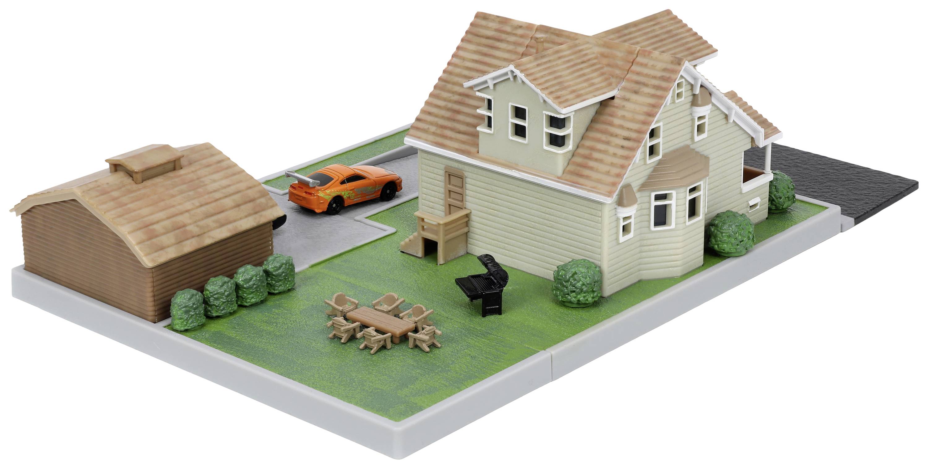 A model of a house with a garage, garden furniture and a car. The house has a red tiled roof and is surrounded by green spaces.