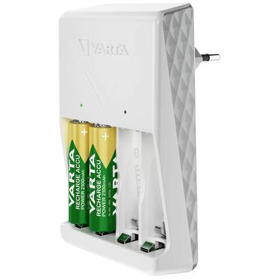 A battery charger with two inserted, rechargeable Varta batteries and two empty battery compartments, plugged into a mains socket.