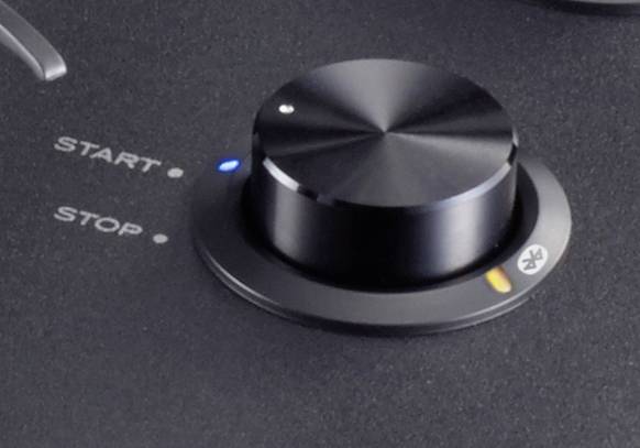 Black control panel with a large rotary knob in the centre. Two buttons labelled 'START' and 'STOP' to the left.
