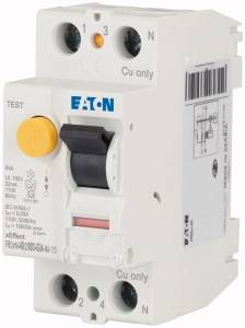 A white protective switch with a yellow test button and black lever, labelled 'EATON'. Cable connections are visible at the top.