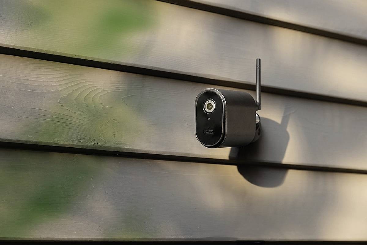 Security camera mounted on an exterior wall, demonstrating modern outdoor security equipment.