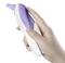 A hand holds a digital ear thermometer in purple and white. The thermometer is being held ready to measure body temperature.