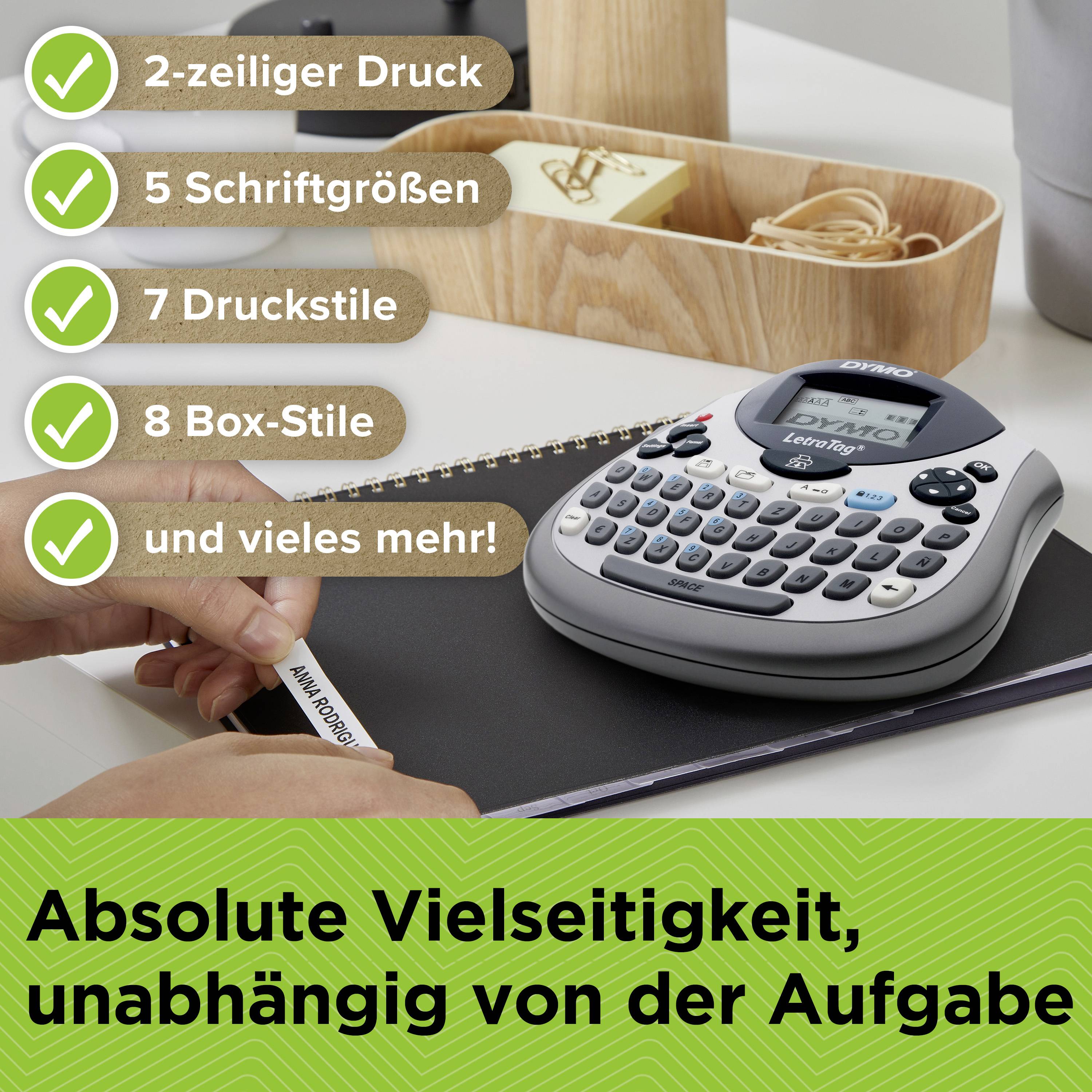 'Total versatility, regardless of the task' is written at the bottom edge. In the foreground, a label printer can be seen.