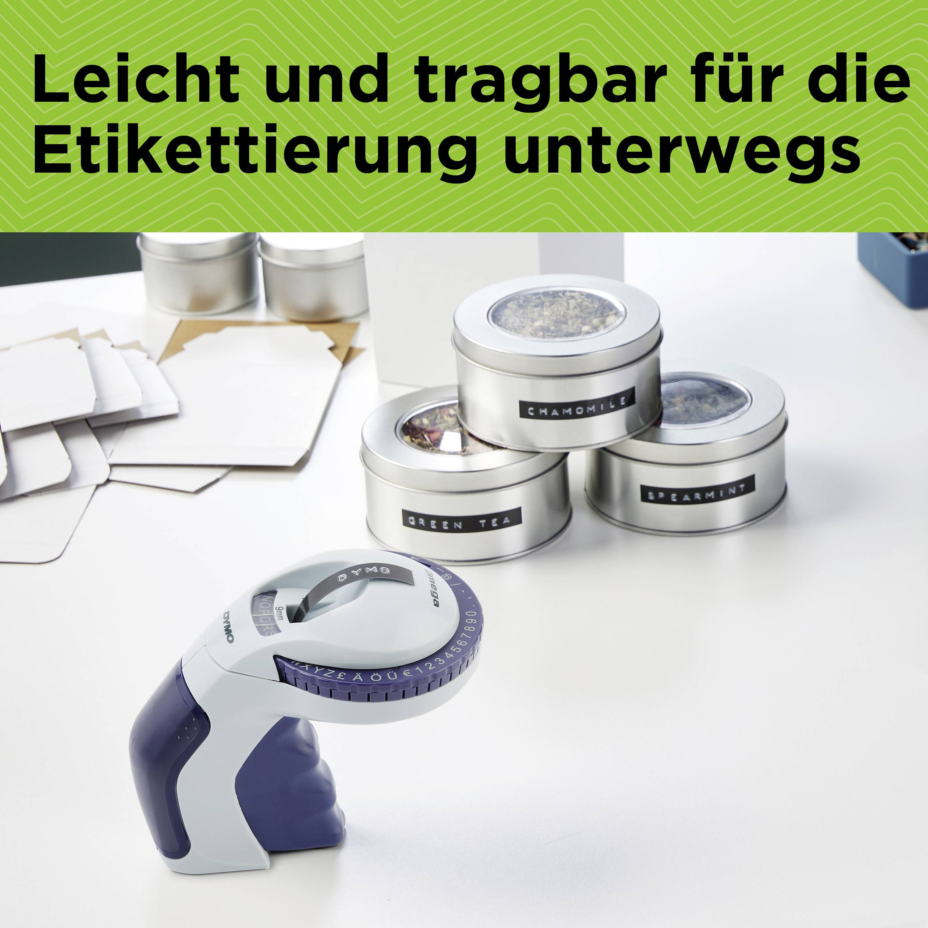 A hand labeller on a table with various tea tins. At the top it reads: 'Light and portable for labelling on the go'.