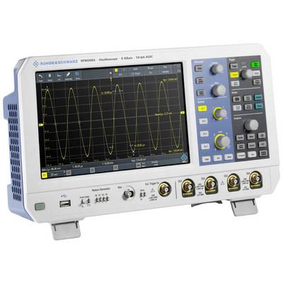 An oscilloscope with a graphical display shows a sinusoidal waveform. Controls and sockets are visible on the front panel.