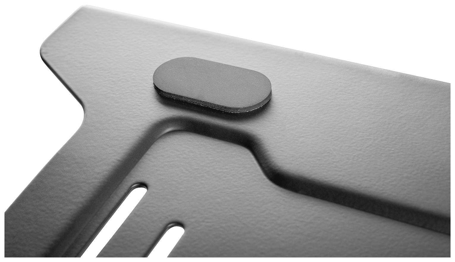 A close-up of a metallic corner with an oval black element on the surface. The structure is smooth and glossy.