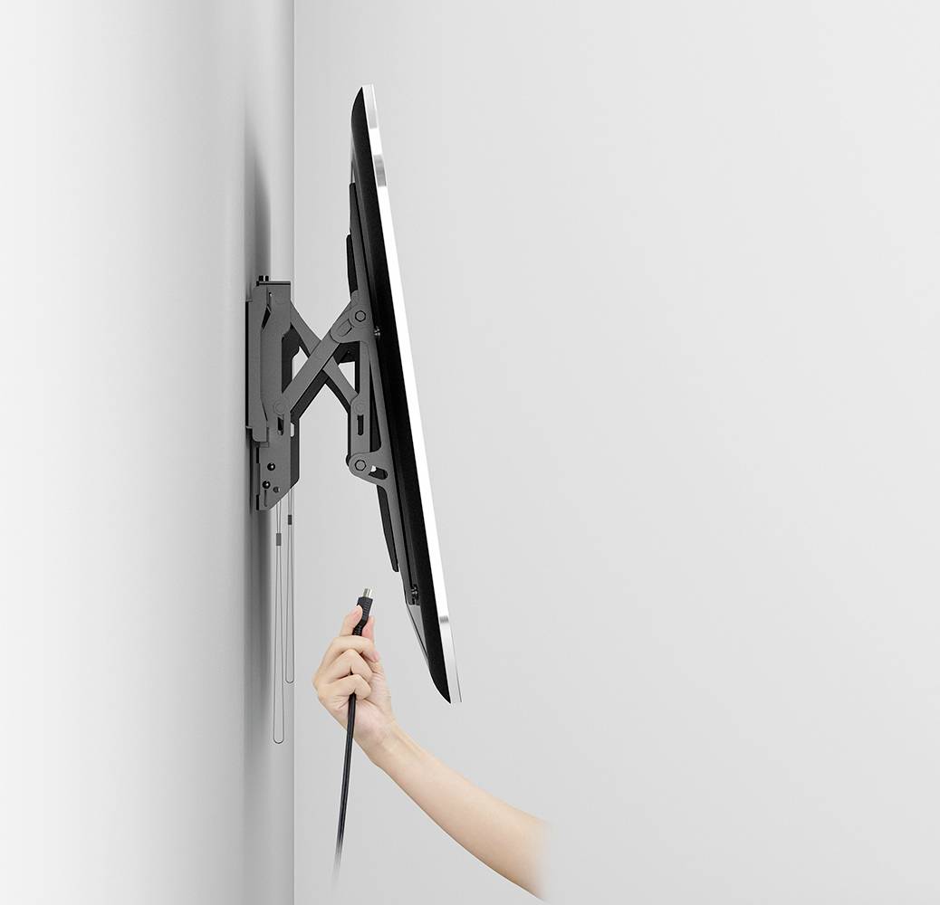 'Pictured is a monitor mounted on the wall, which is being connected to a hand via a cable.'