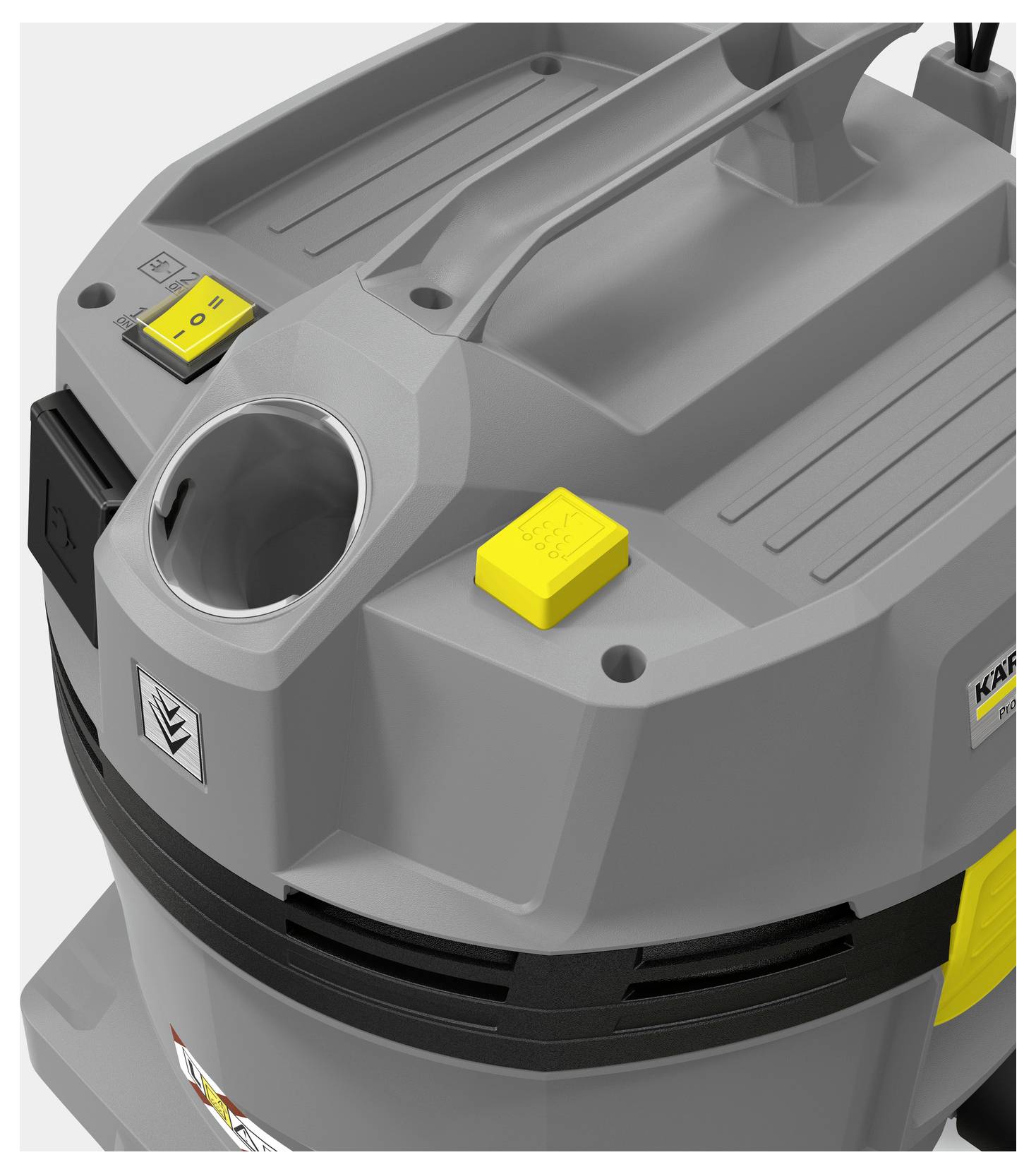 A close-up of a gray industrial vacuum cleaner featuring a handle, two yellow buttons, and a circular opening on its top surface.