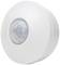 A white, circular motion sensor with a central lens, designed to monitor movements within a room.