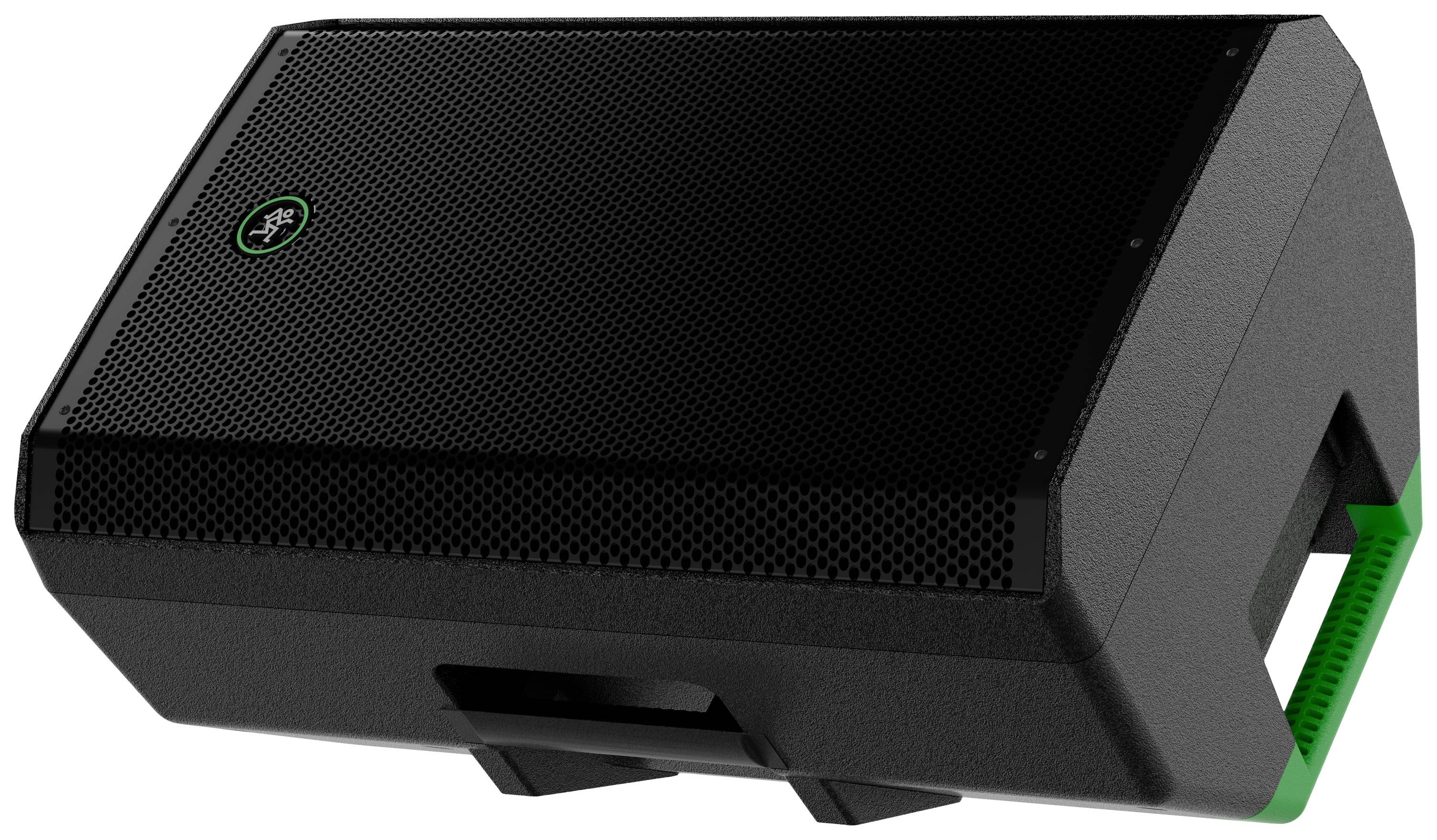 A black speaker with green accents lies on its side. The enclosure is robust and designed for powerful audio output.