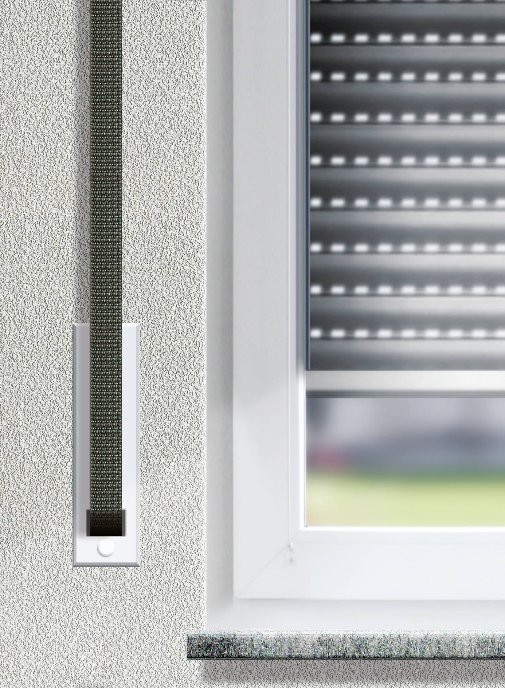 At a window with an internal roller blind, a roller blind strap is attached to the wall. The window shows a blurred outdoor area.
