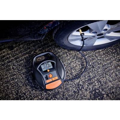 A digital tyre inflator is pumping a car tyre. The display shows '0.25', corresponding to the current tyre pressure.