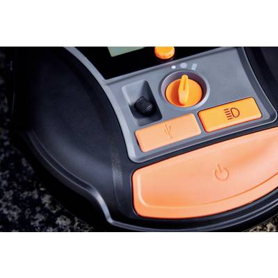 A close-up of an electronic control panel with orange buttons and a rotary switch, possibly part of a device.