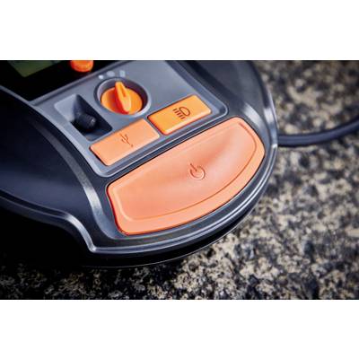 The image shows a close-up of an Automower control panel with orange buttons for various functions, set against a stone surface.