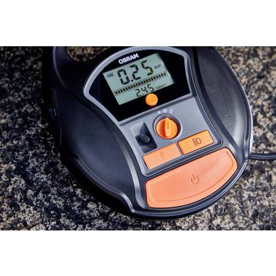 A digital device with a display shows '0.25 BAR'. It has controls for air pressure measurement and two orange switches.