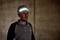 A man in sportswear is wearing a luminous headband in a dark room.