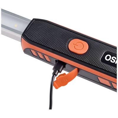 A charger is plugged into a portable lamp. It is black and orange and shows a power button.
