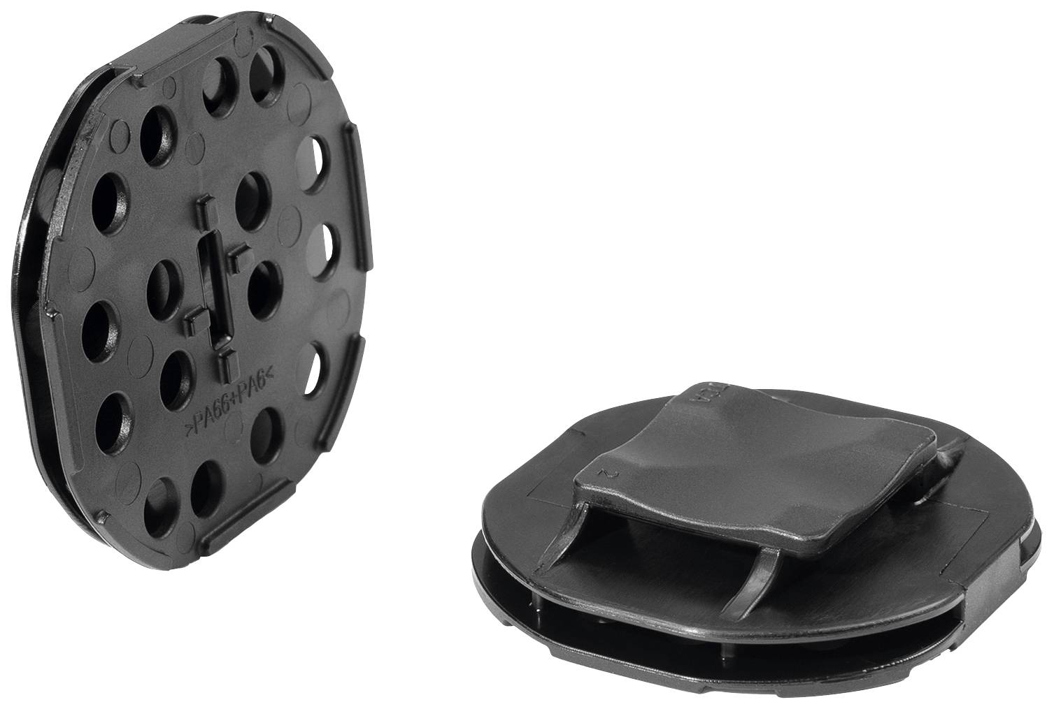 Two black, round plastic parts, perforated; right-hand part has two protruding tabs, showing different perspectives.