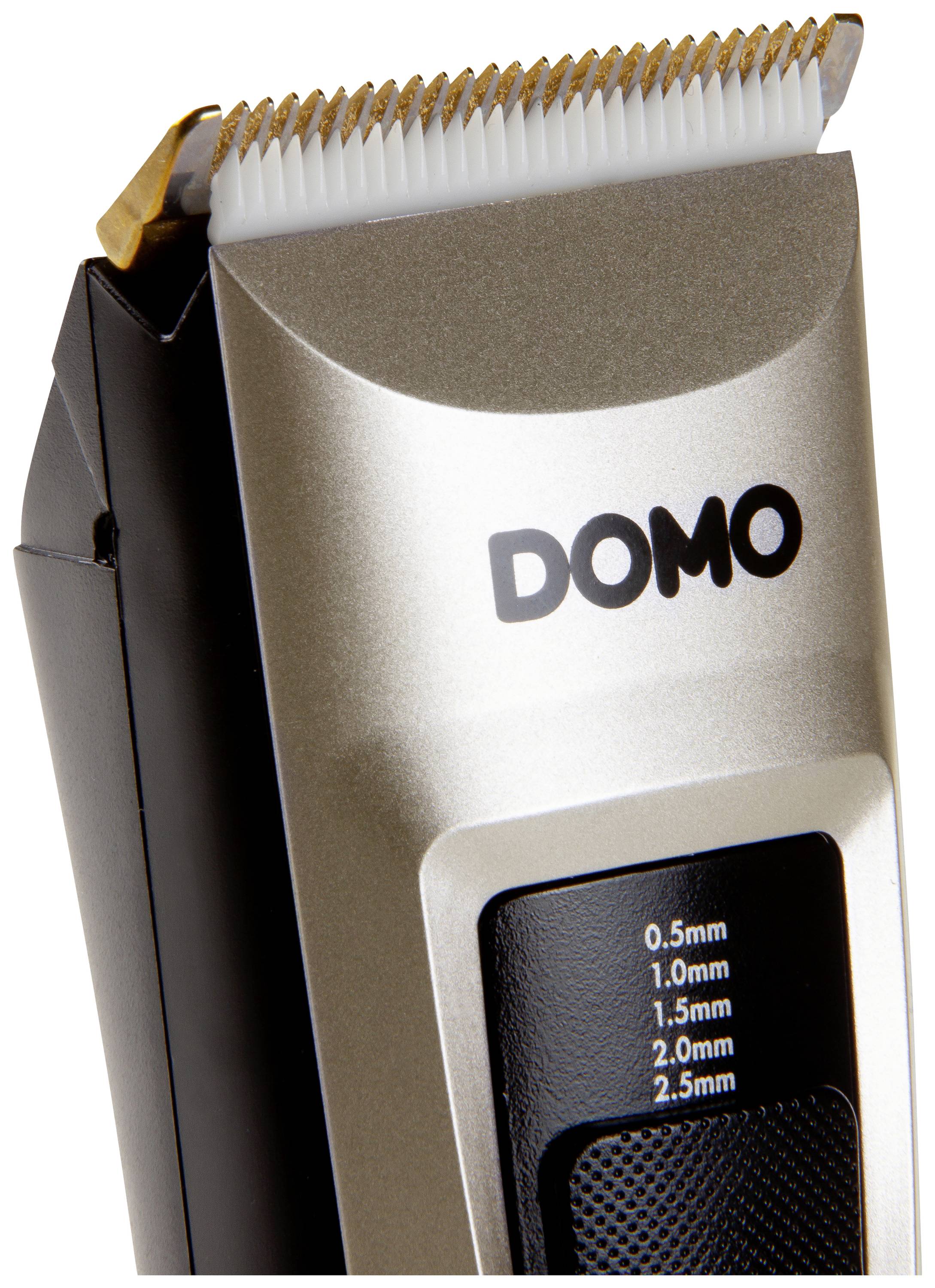 Close-up of a silver electric hair trimmer with black accents and a scale for cutting lengths from 0.5 to 2.5 mm.