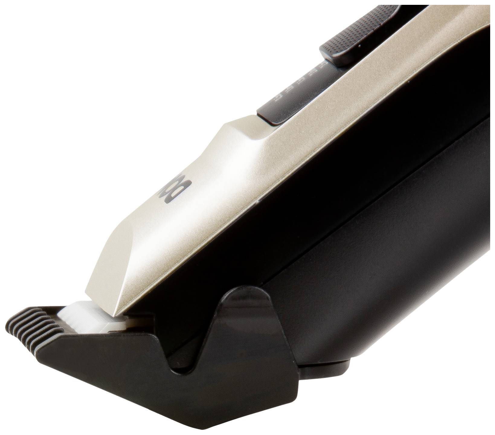Electric hair clipper in close-up, showing the cutting blade and the black handle with a silver accent.
