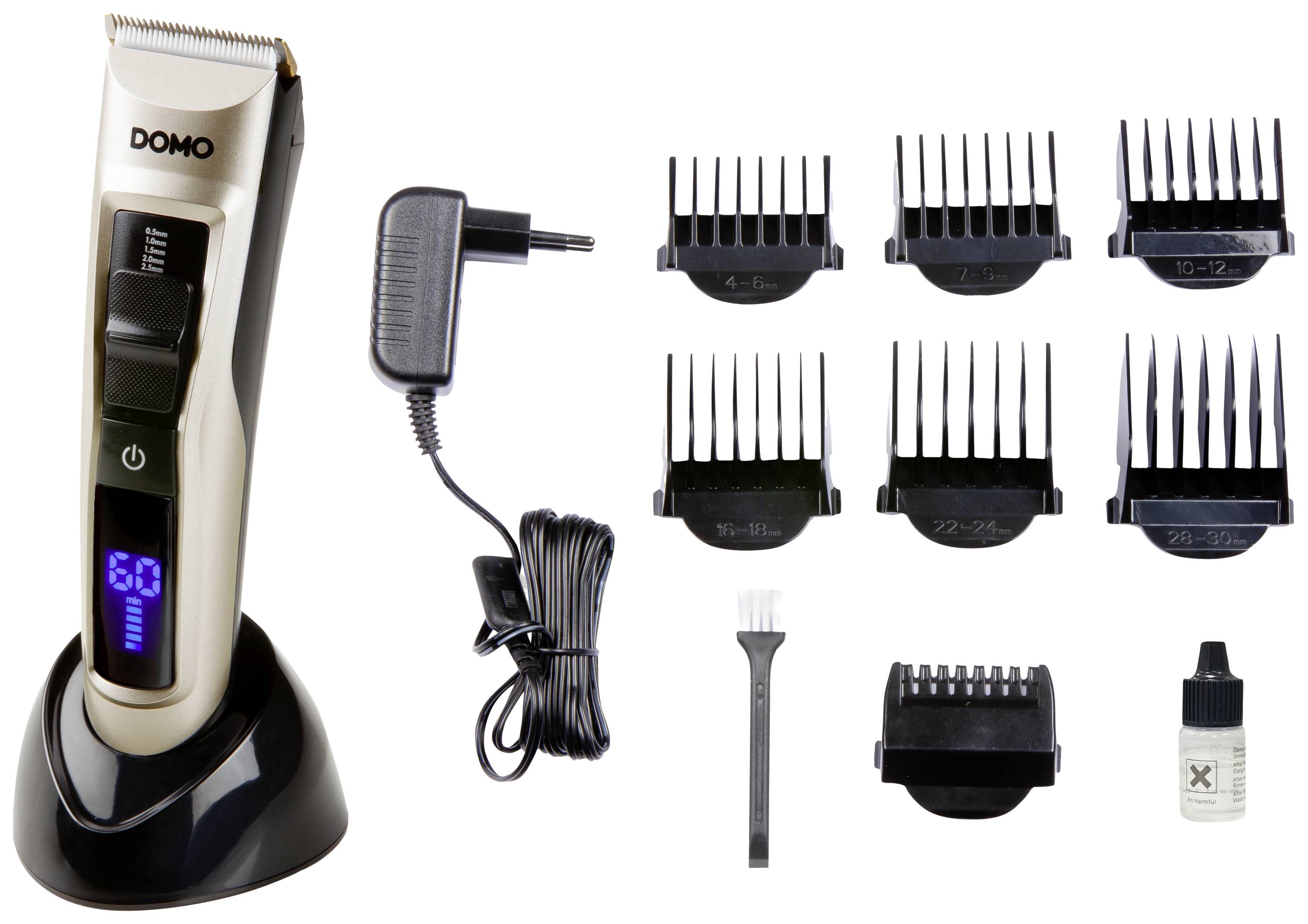 Electric hair clipper with various attachments, charging station, cleaning brush and small oil bottle for blade maintenance.