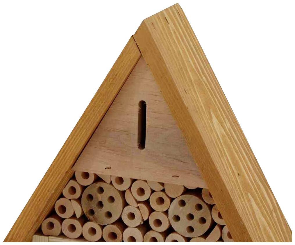 An insect hotel with multiple holes in wooden discs provides shelter for bees and other pollinating insects.