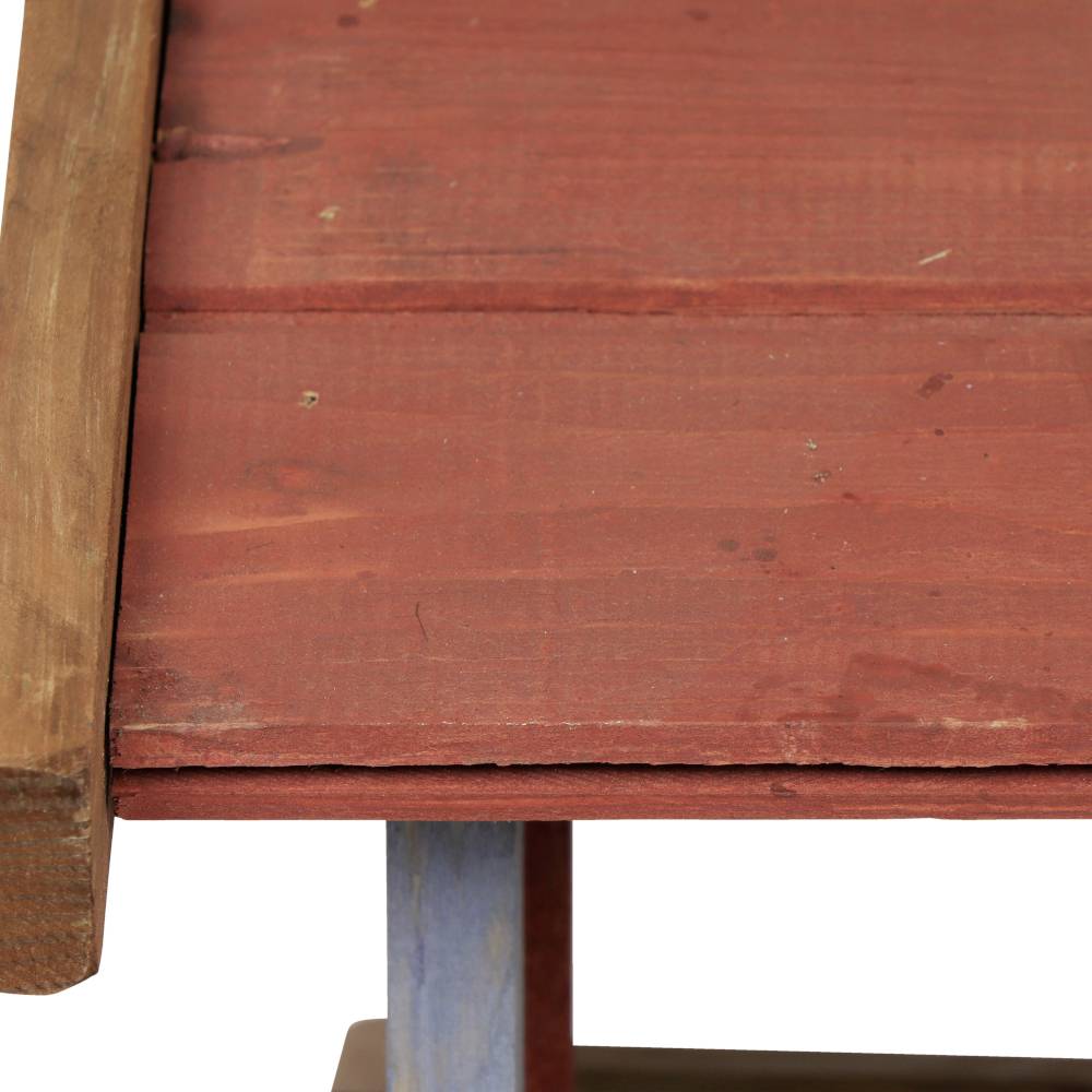 Close-up of a wooden table with a reddish-brown surface and blue legs.