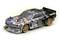 Model car of a racing car with stickers and decorations in the style of the US flag. The car has golden alloy wheels and a sporty design.