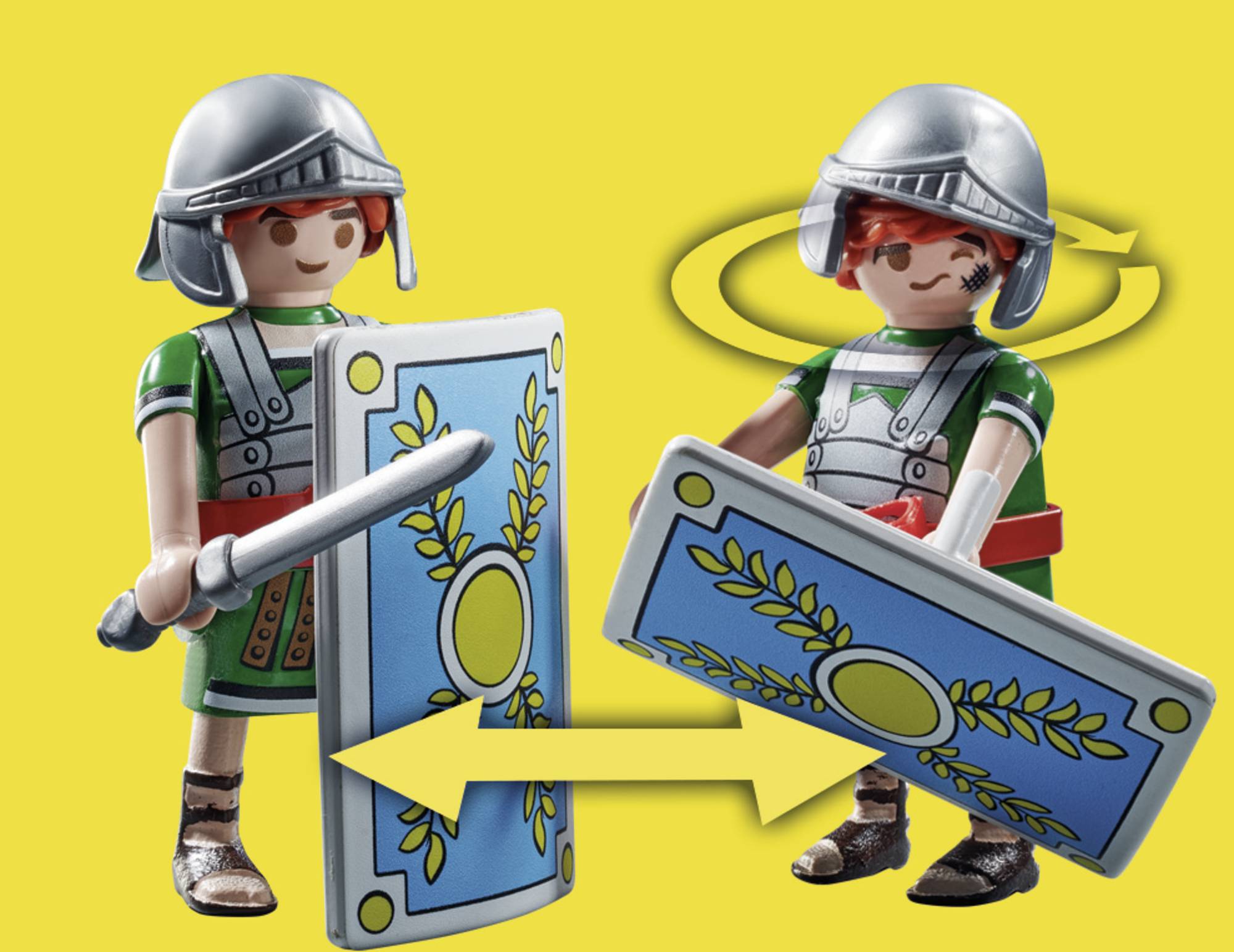 Two toy soldiers with helmets and armour stand facing each other, shields and swords pointing forwards.