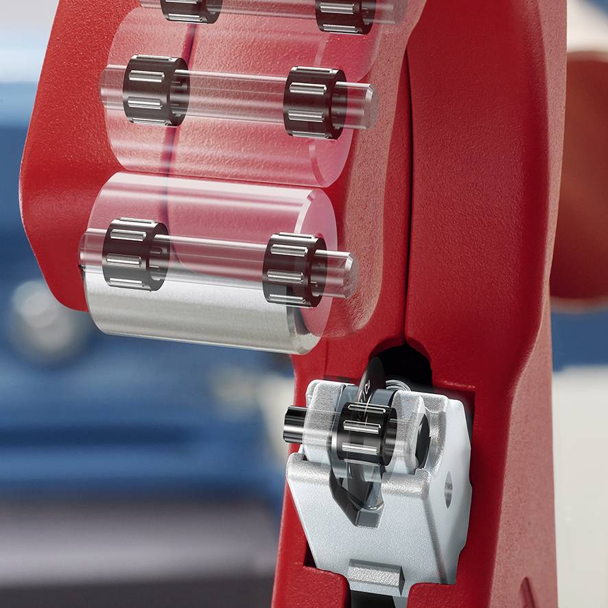 A red tape dispenser with transparent adhesive tape. Blurred in the background.