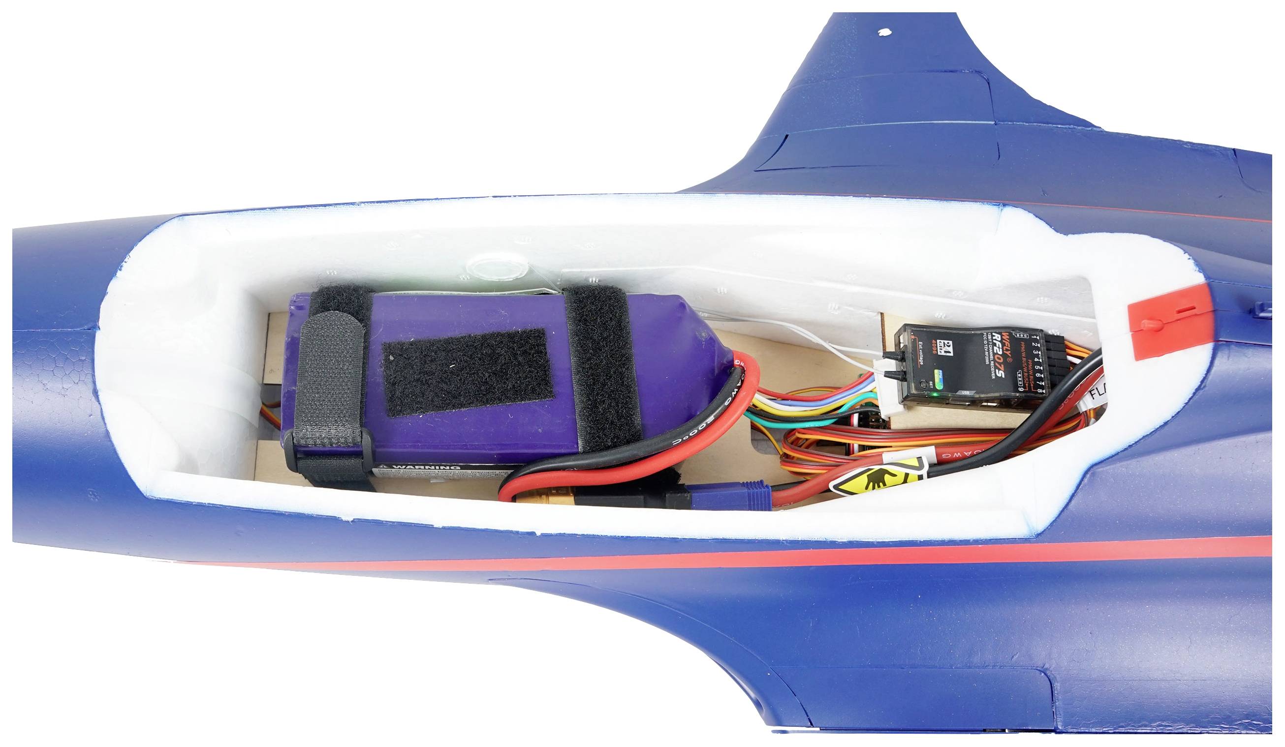 Blue model aircraft with removed fuselage cover reveals internal wiring and an inserted battery.