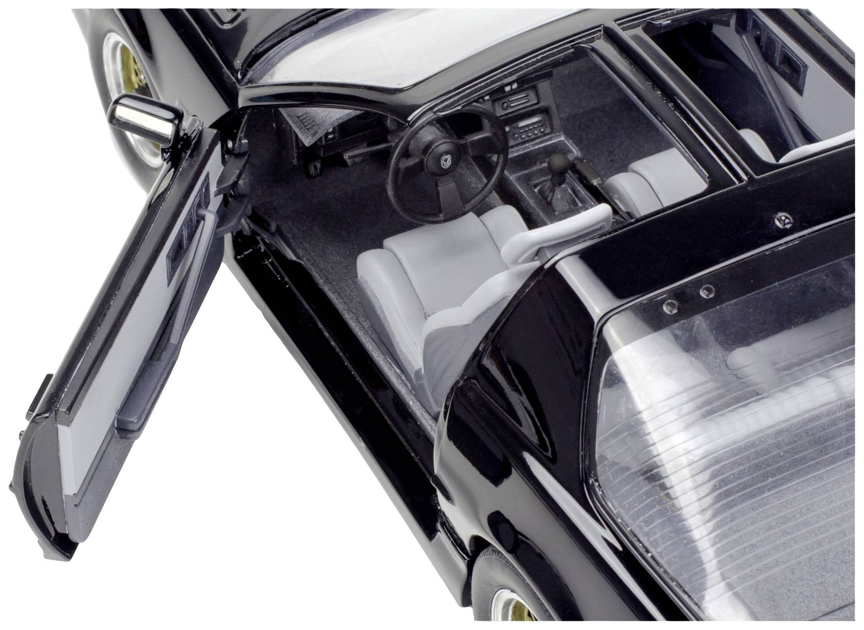 Black model car viewed from above, driver's door open, showing steering wheel and seats in the grey interior. Focused on vehicle design.