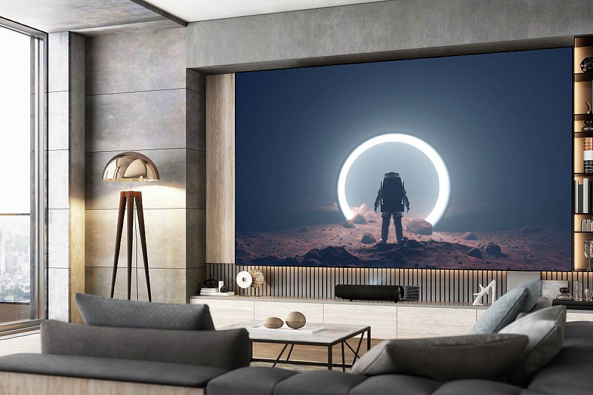 An astronaut stands on a red planetary floor in front of a luminous circle, surrounded by modern interior design.