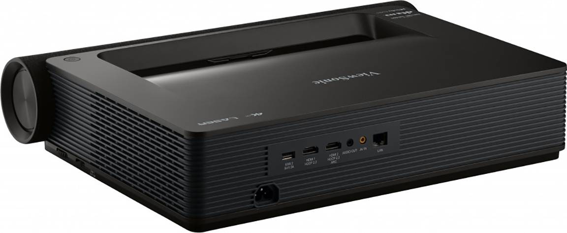 A black multimedia projector with multiple inputs, including HDMI and USB ports, positioned on a table.