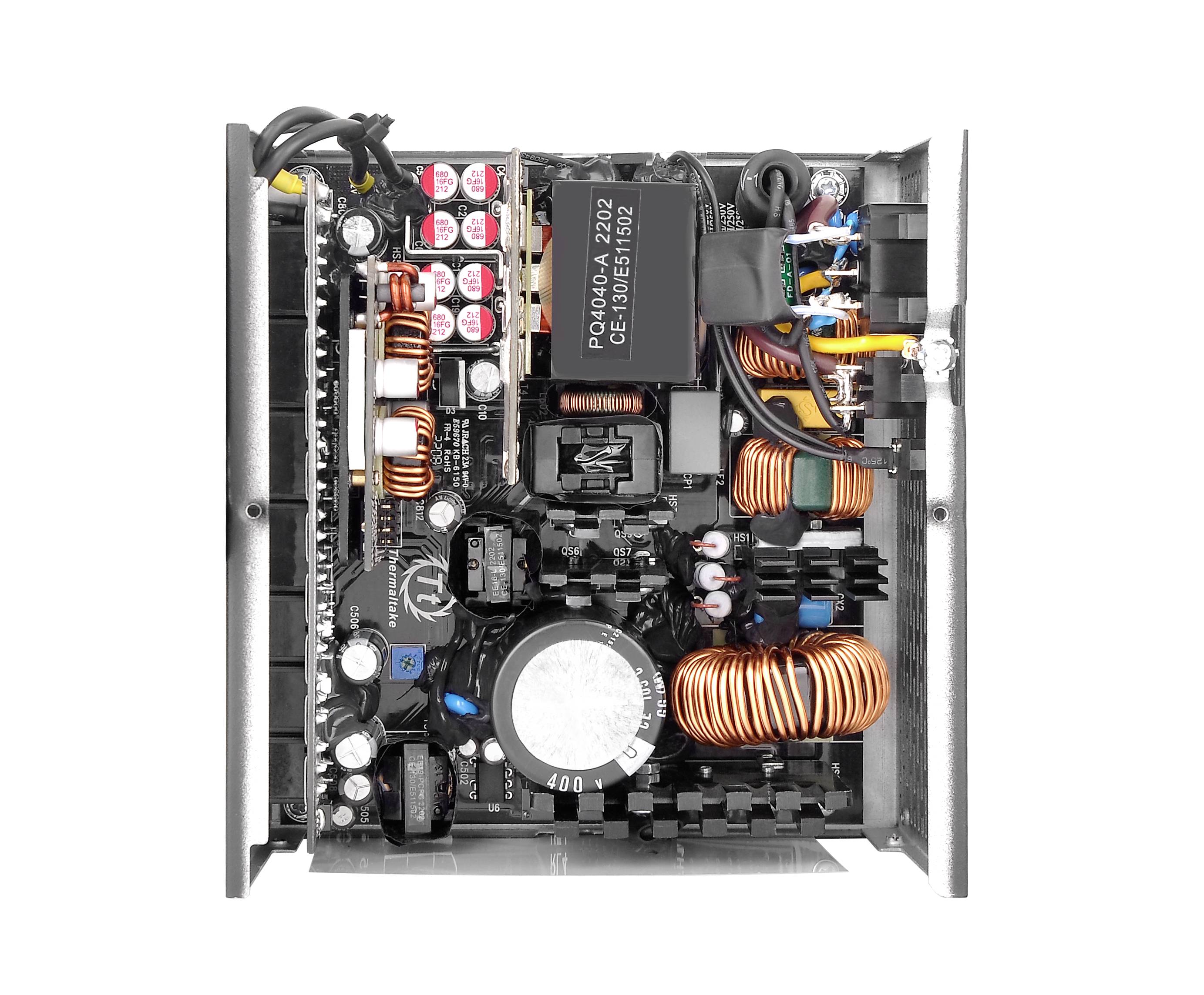 Power supply unit inside a computer, showing various electronic components such as capacitors, inductors, and cables.