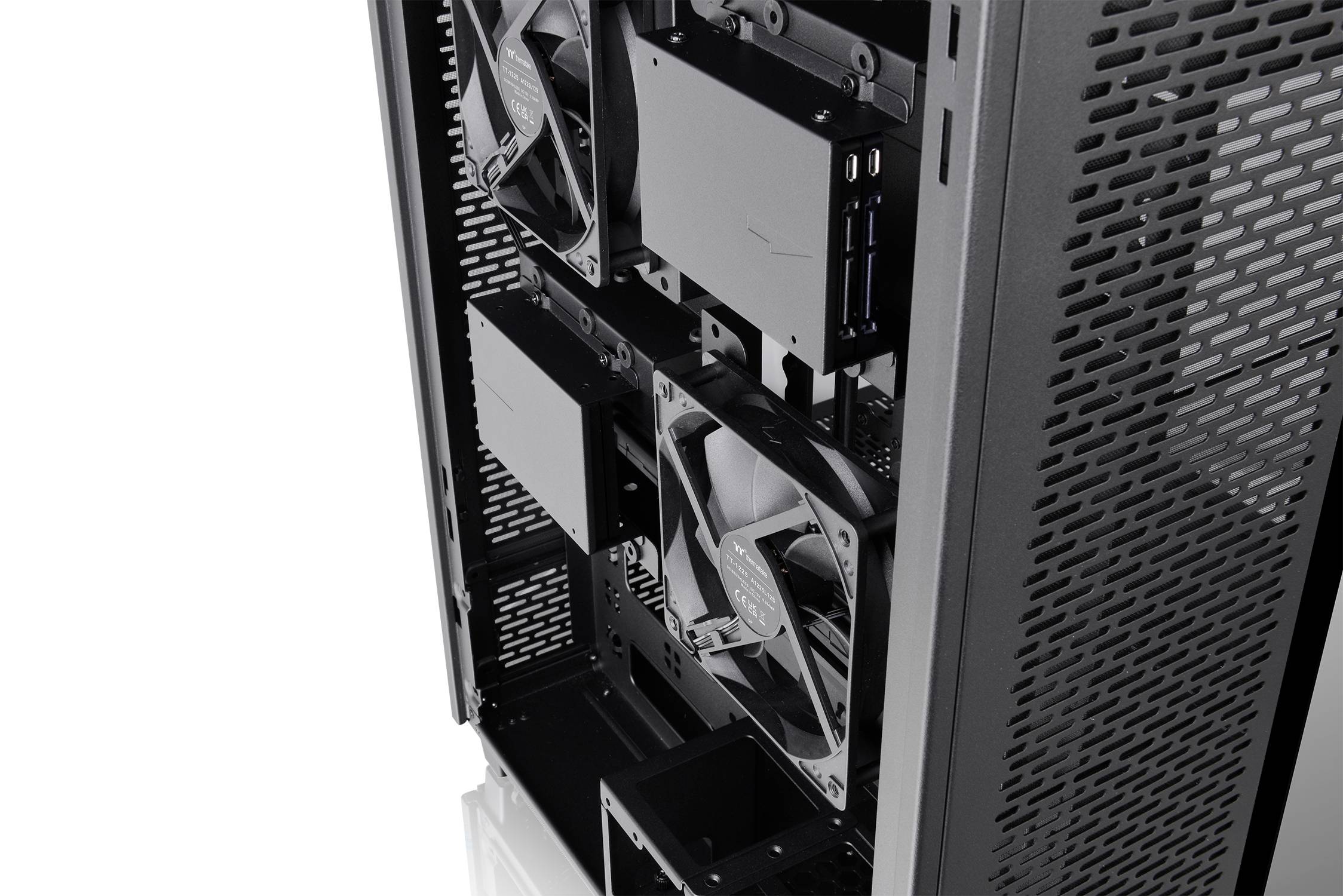 Interior view of a computer case with visibly installed fans and components, without illuminated elements.