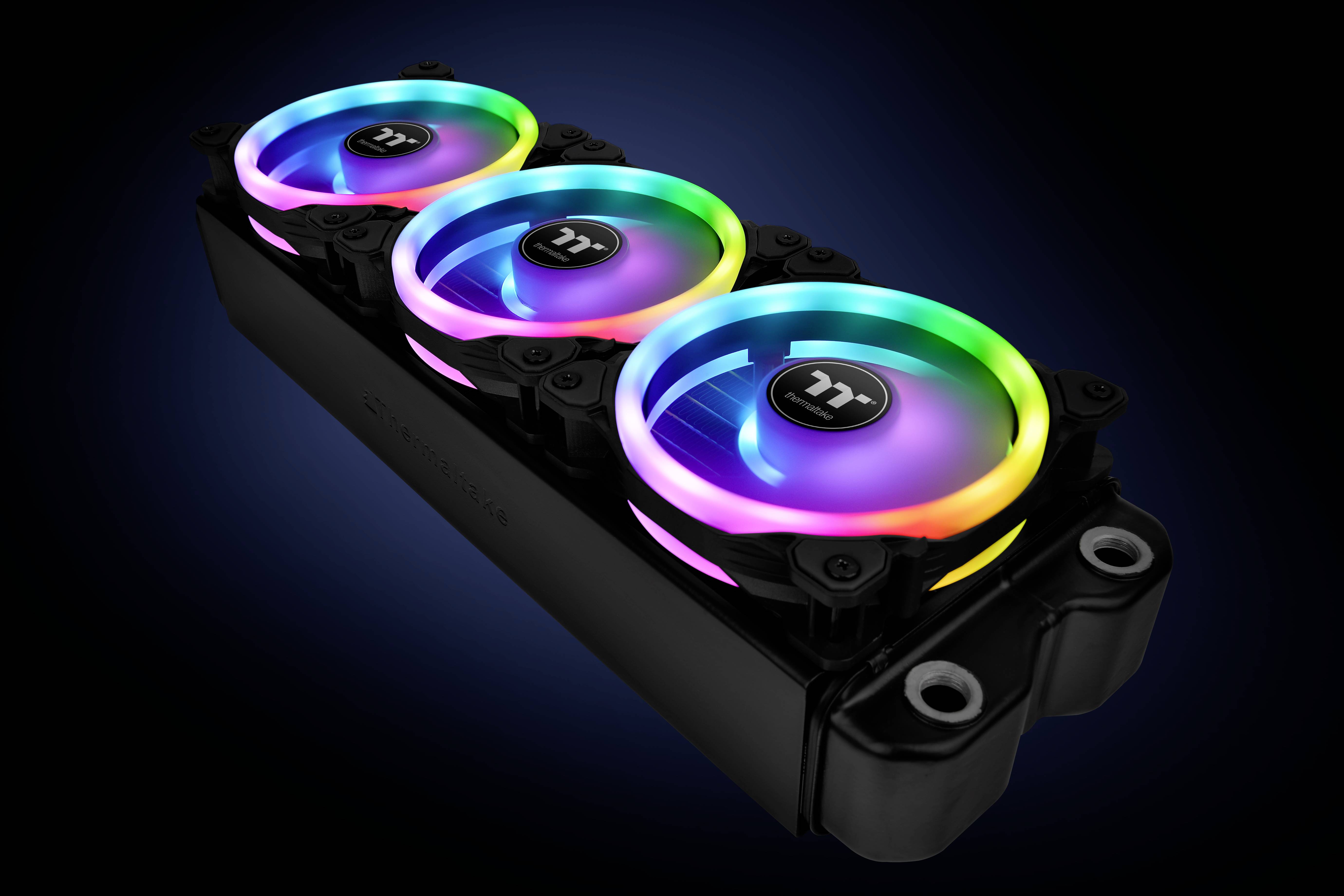 Three computer fans with colourful RGB lights, mounted on a black heatsink. They are glowing in different colours.