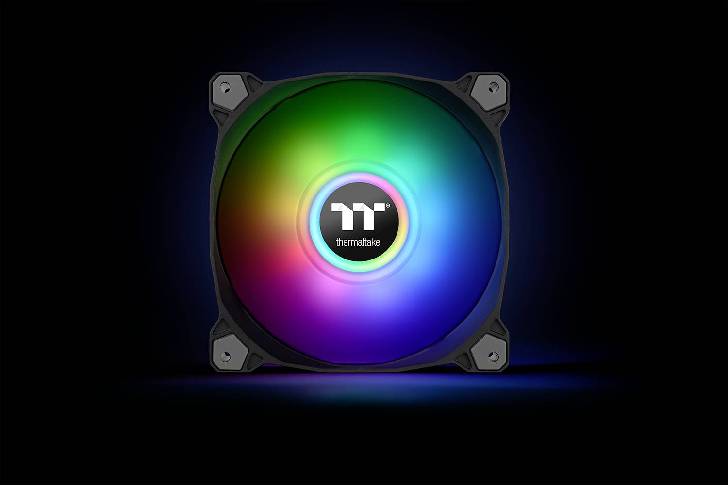 A round, illuminated computer fan with a rainbow effect on a black background, marked with 'Thermaltake' in the centre.
