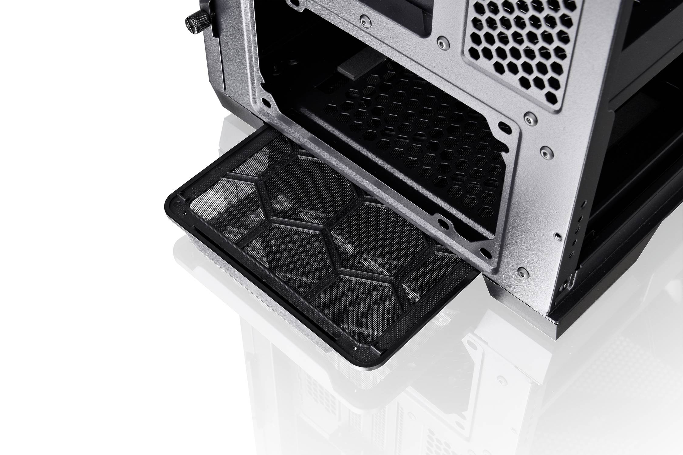 A computer case with a pull-out dust filter for easy cleaning. The filter is black and honeycomb-shaped.