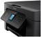 A black printer with a side control panel and display. The display shows an ink cartridge. Brand: Epson.